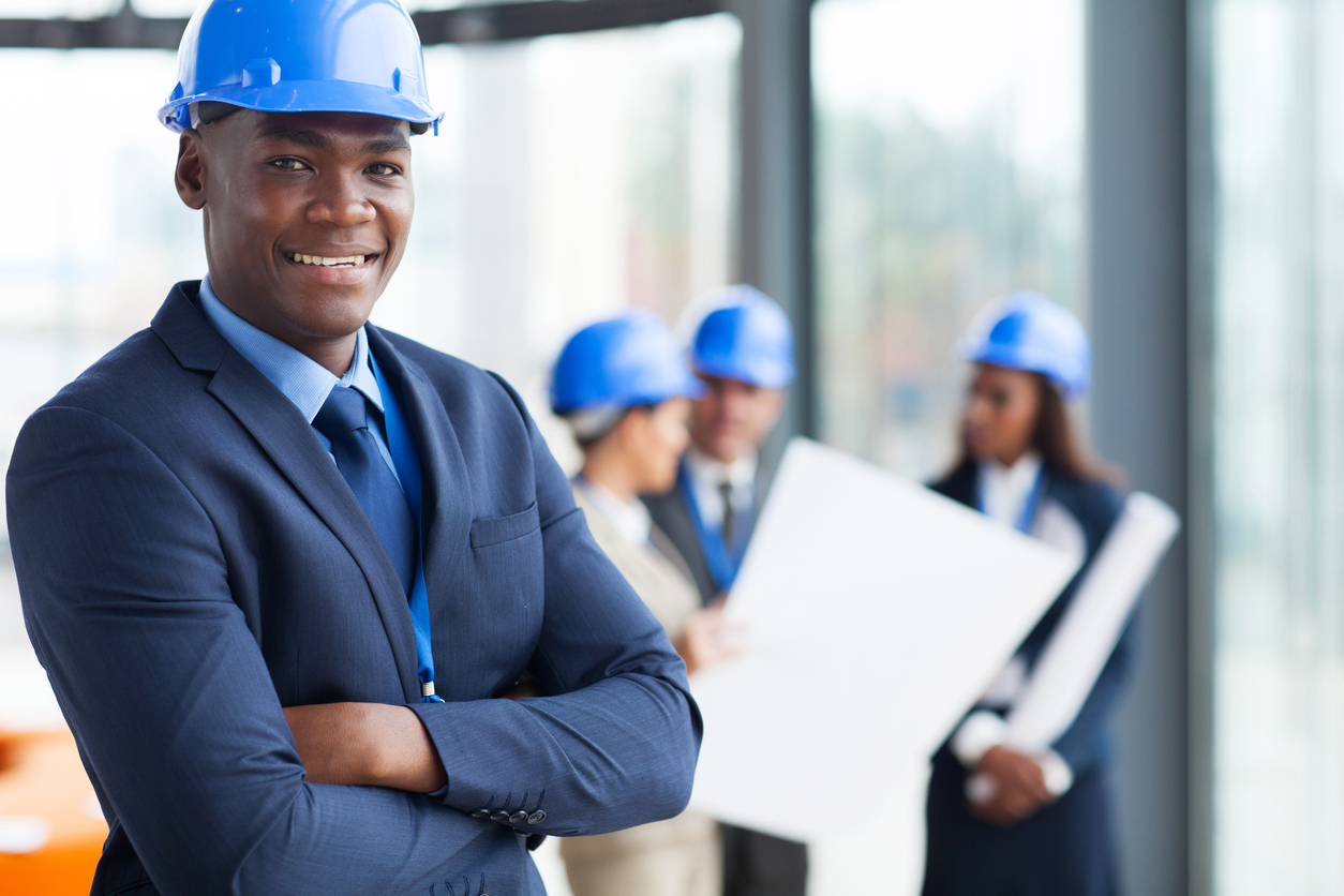 african male construction manager with arms folded