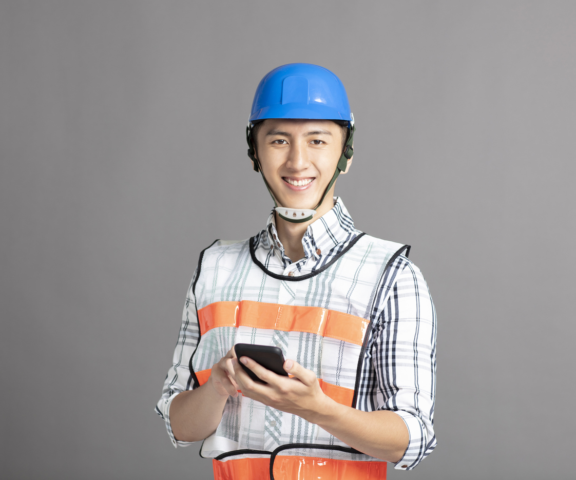 smiling asian young man construction worker