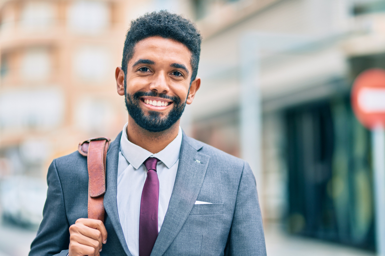 Young african american businessman smiling happy standing at the city.